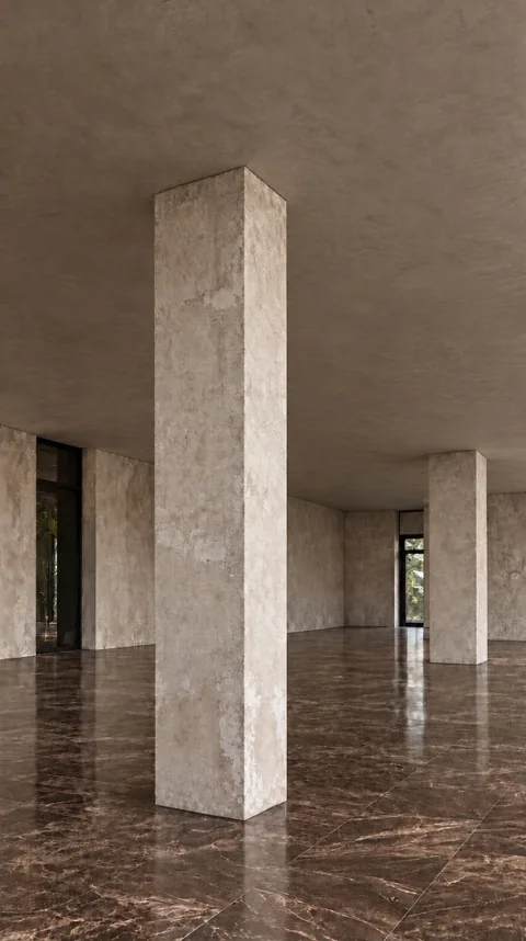 An empty room with bare concrete columns and a marble floor